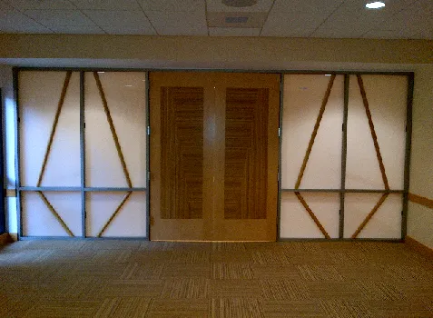 VT wood veneer double doors installed between two protected sidelight openings in a commercial interior