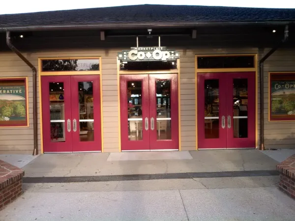 Red Special-Lite FRP double doors with glass lites at a theme park attraction building