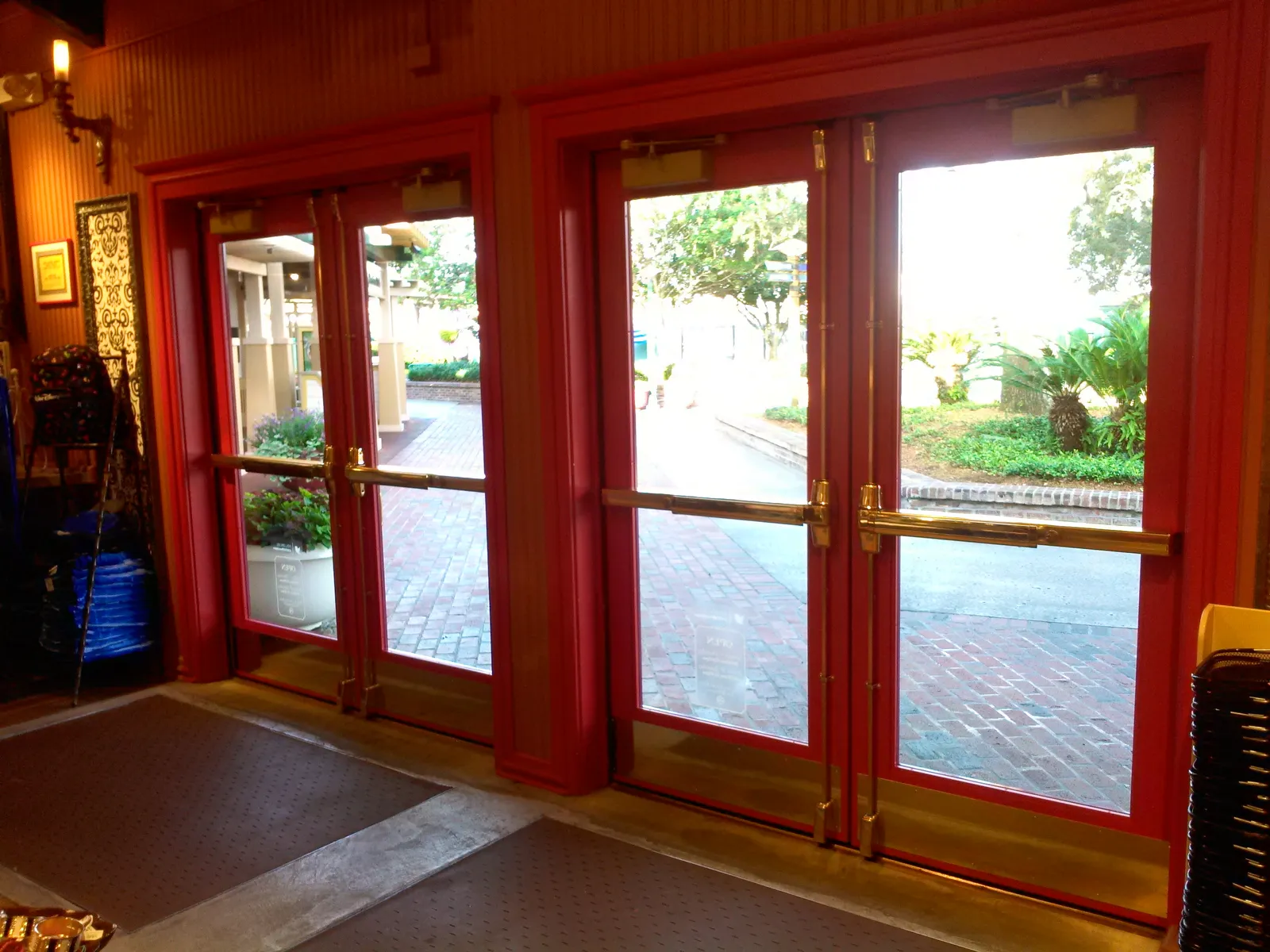 Red FRP double entry doors with full glass lites at a commercial building entrance