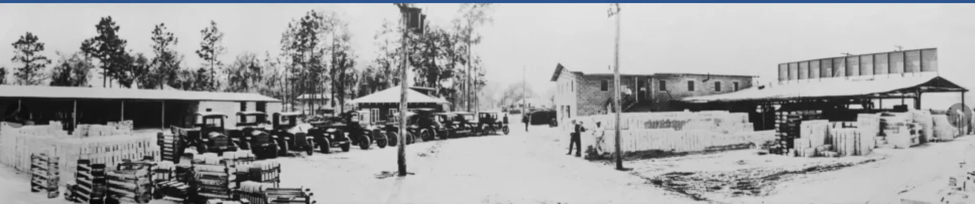 Historic Mills & Nebraska lumber yard with trucks and building materials