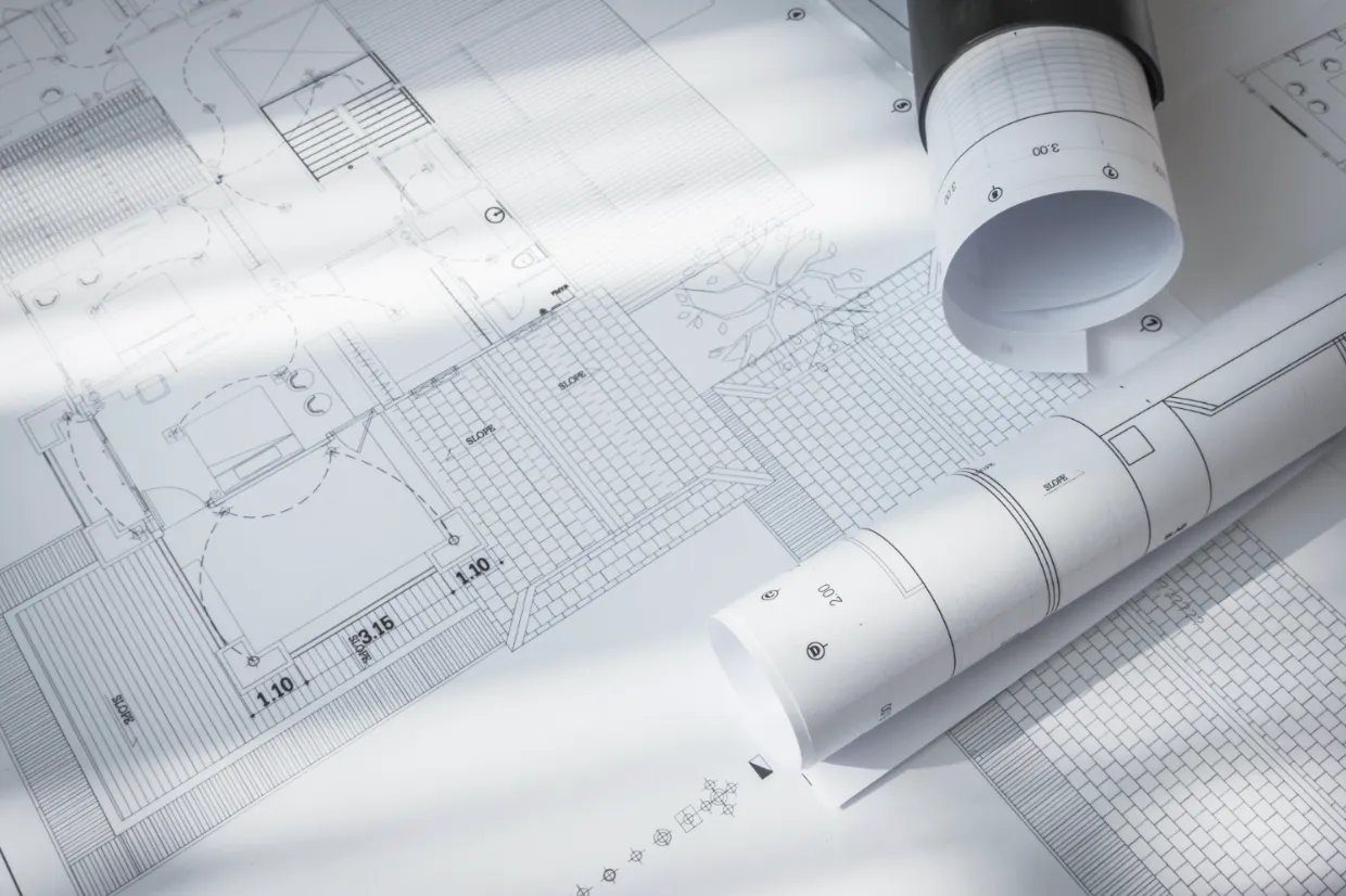 Rolled and flat construction blueprints used for specification and project planning