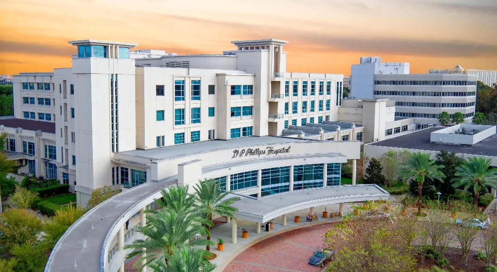 Orlando Health Dr. P. Phillips Hospital in Orlando, Florida, with its curved covered entrance drive and multi-story patient towers