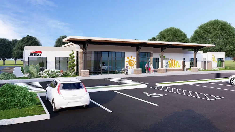 Rendering of the Southeastern University early childhood center in Lakeland, Florida, a one-story building with a covered entry and sun mural beside a parking lot