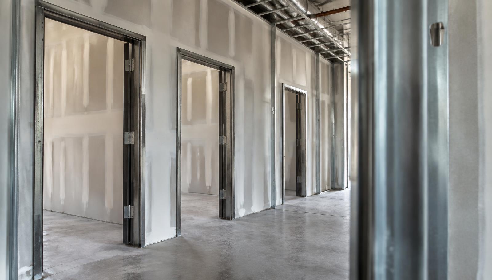 Dark gray hollow metal door frame installed in a white interior wall